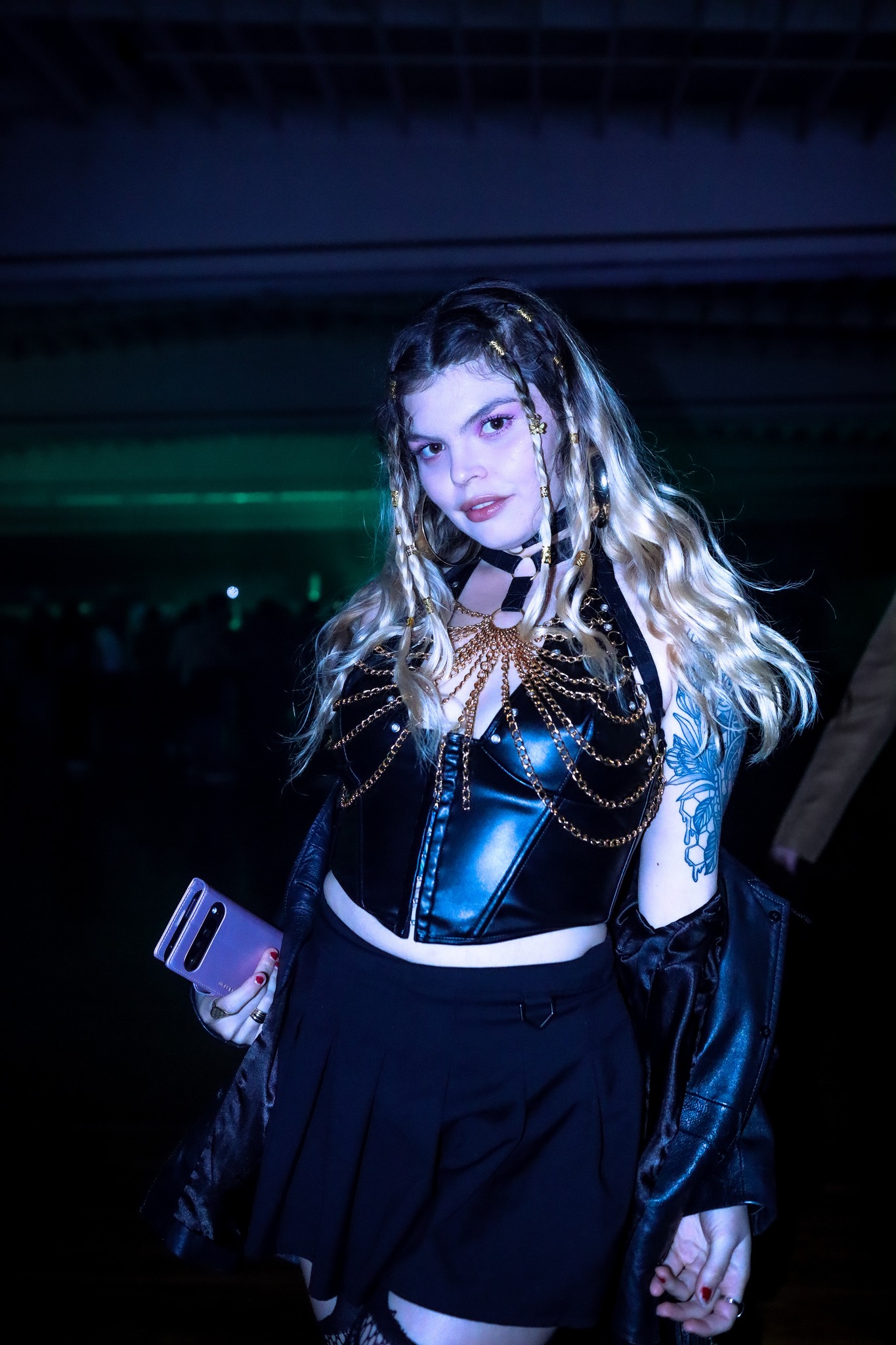 Crowd dancing under neon pink and cyan lights at Planet Rave Y2K25 San Diego