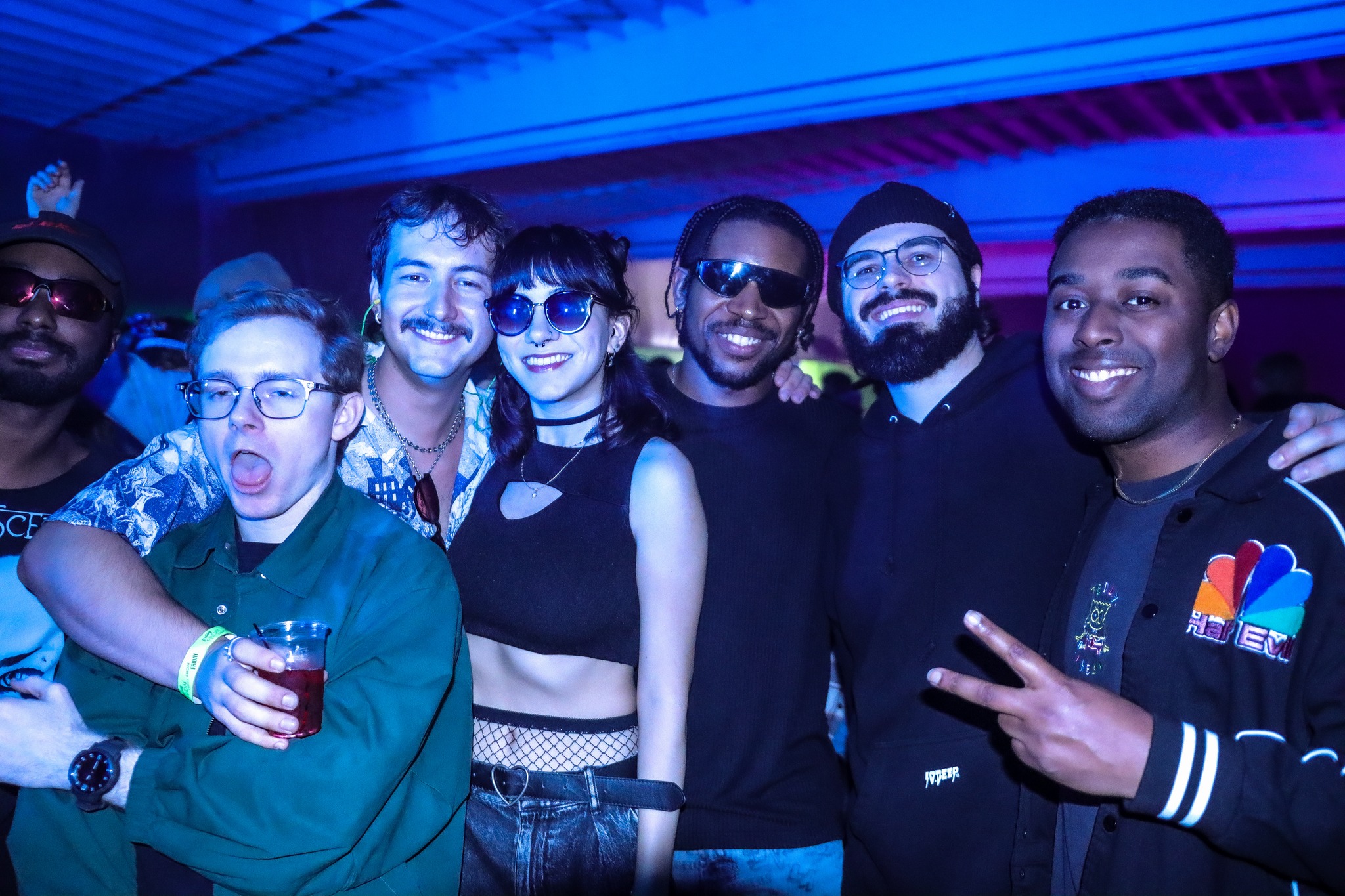 Friends dancing together at San Diego underground rave