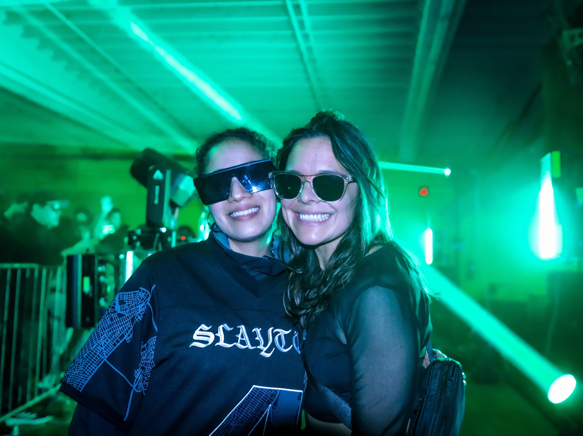 Ravers lit by magenta stage wash at underground event