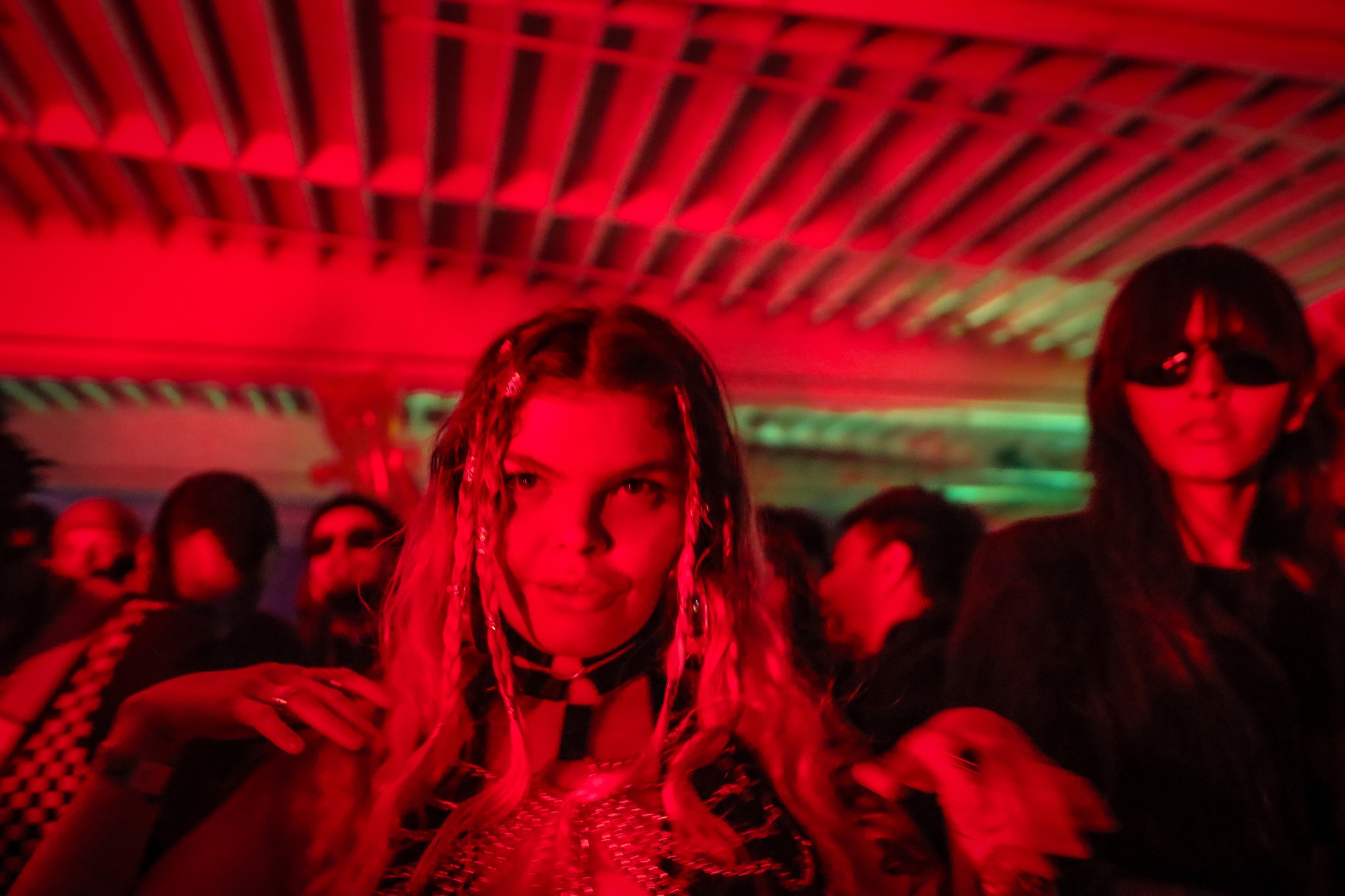 Ravers with glow sticks and kandi bracelets on the dance floor