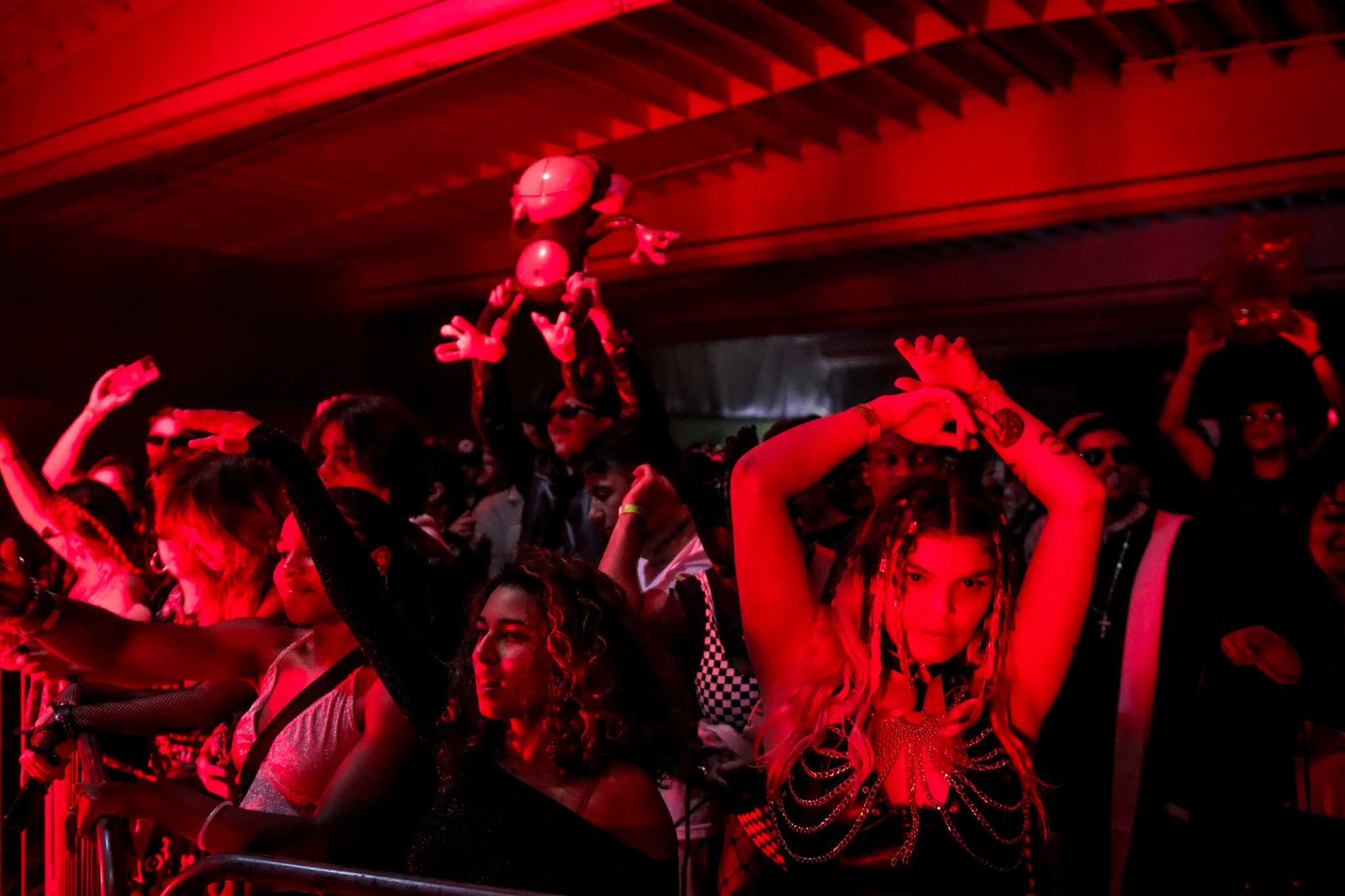 Neon-lit crowd hands raised at San Diego rave